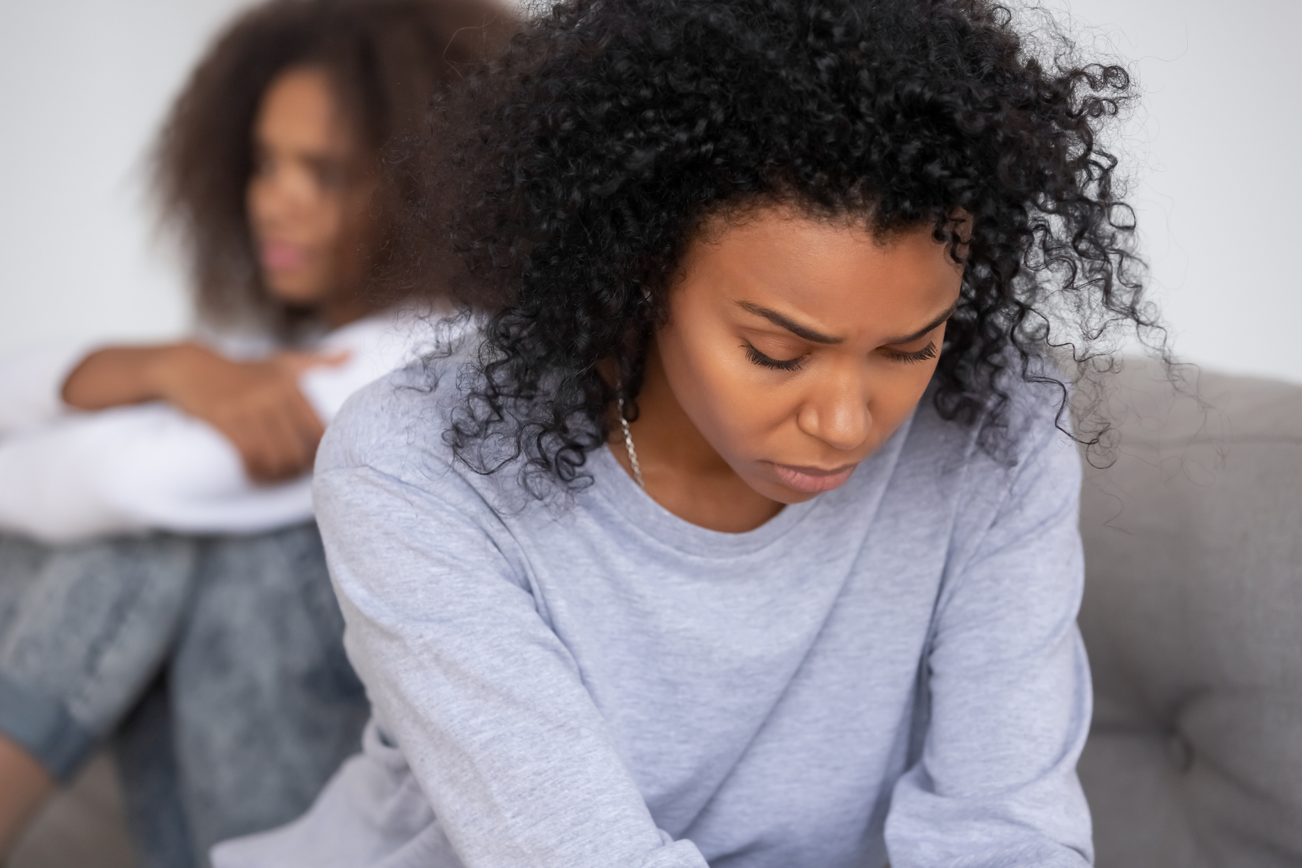 Upset african mom of teen daughter feeling sad after fight